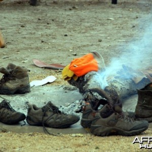 Hunting Shoes Drying Around Camp Fire