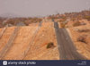 beit-bridge-border-road-and-fence-separating-zimbabwe-and-south-africa-D100C0.jpg