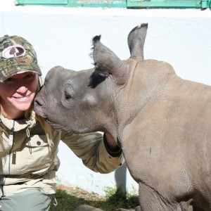 Here is a picture of my wife and the baby rhino on the farm