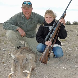 Little girl and first animal in the salt--warthog