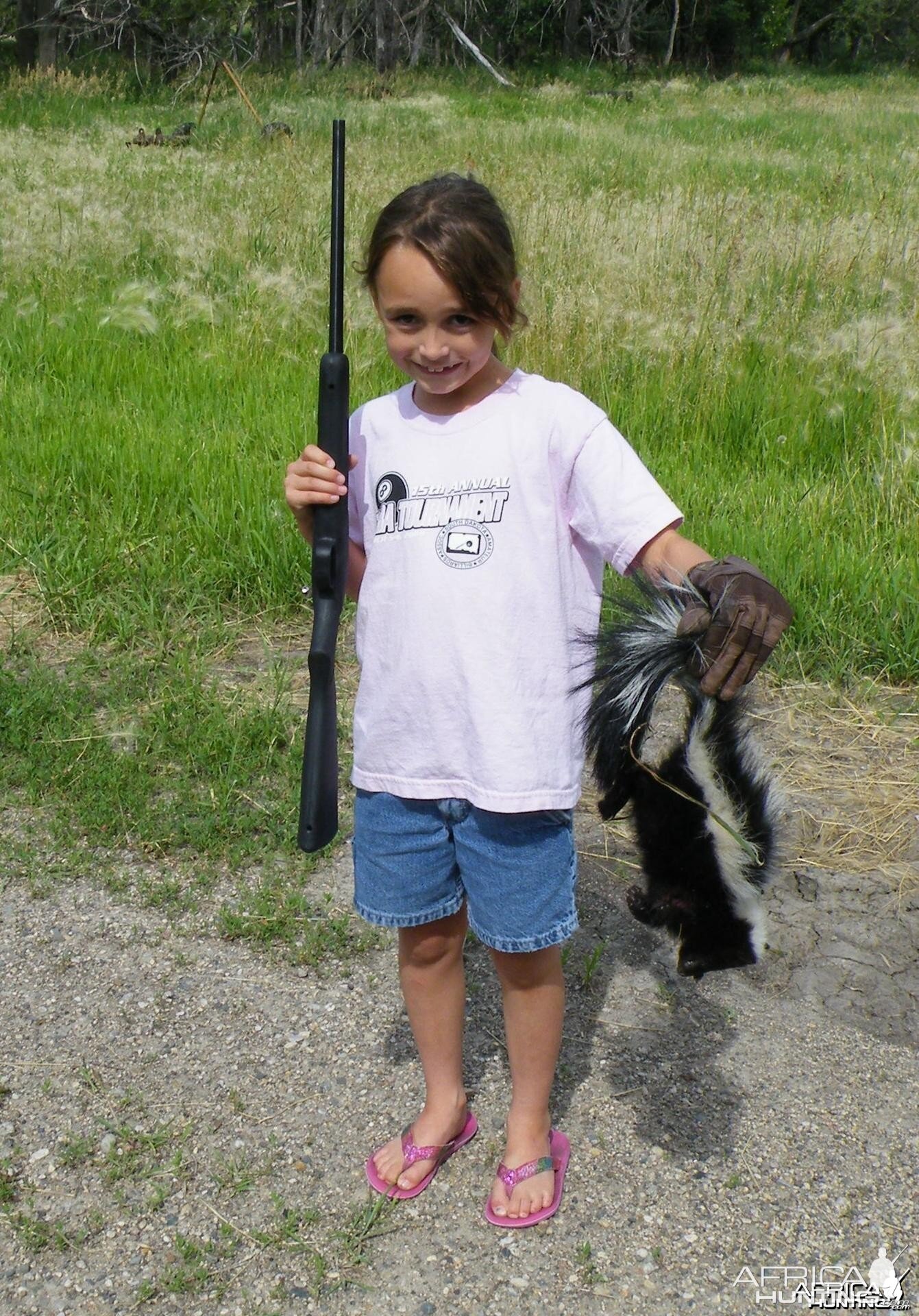 8 year old granddaughters first kill with her new .22, a skunk; PRICELESS